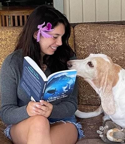 Happy reader reading Where the Honu Swim book